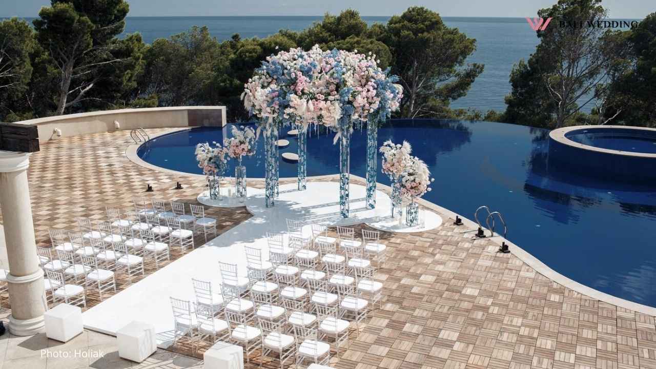 wedding-setup-by-pool-with-ocean-view-and-elegant-floral-decorations Wedding setup by pool with ocean view and elegant floral decorations