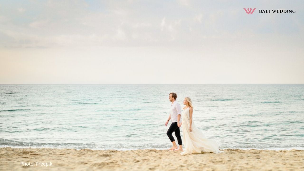 A Wedding Couple Walking Down the Beach