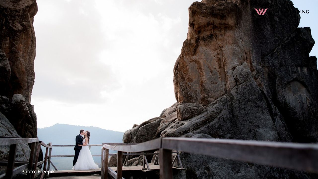 Wedding couple is standing on the wooden bridge
