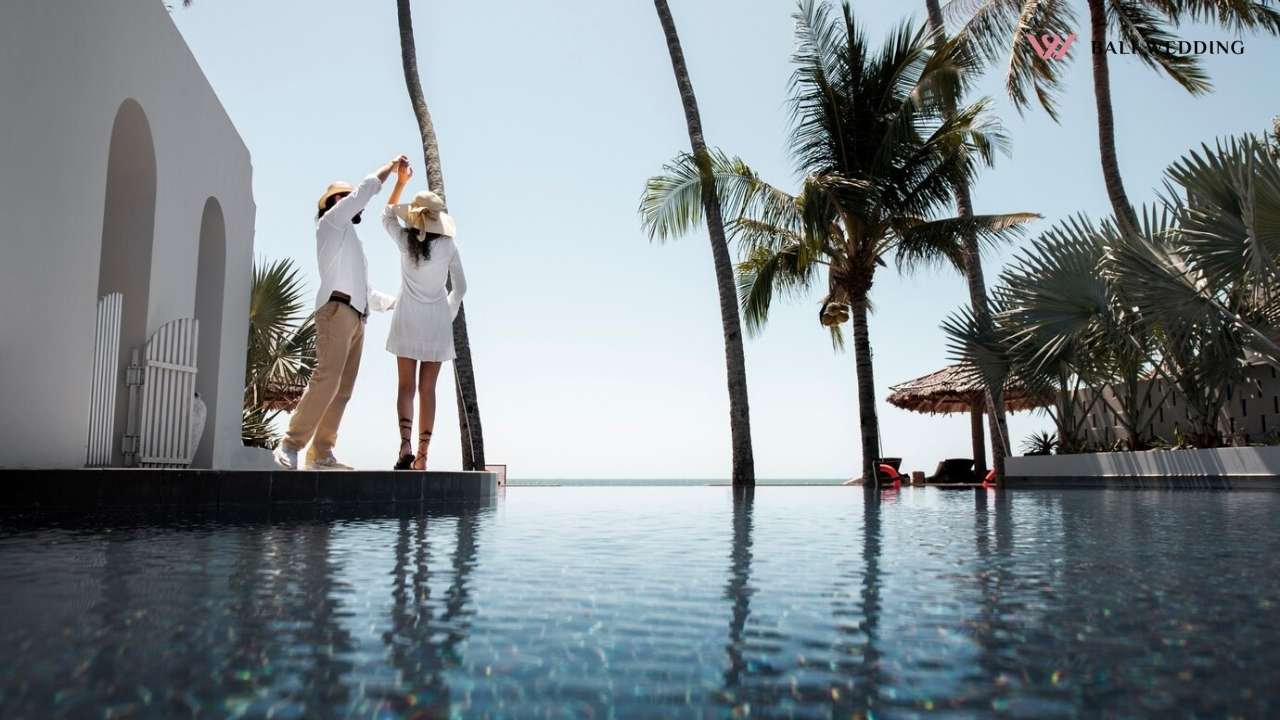 Couple dancing by the pool during vacation