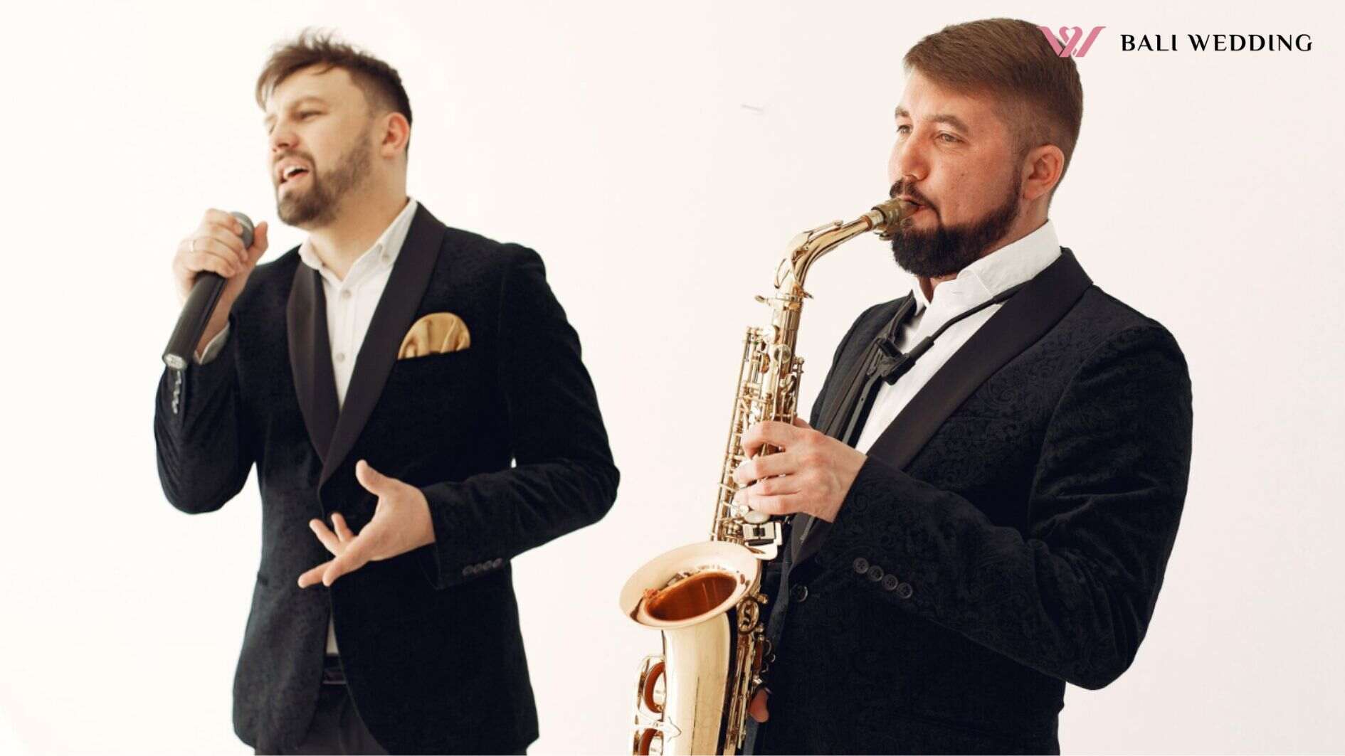 Two adult musicians standing in studio