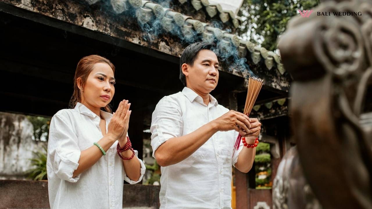 couple during traditional Balinese blessing ceremony at temple