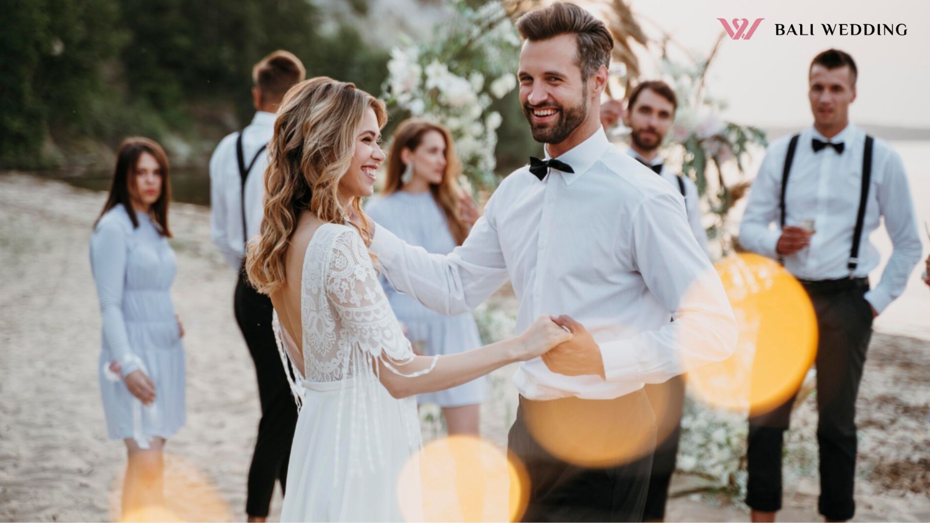 Bride and groom having their wedding with guests on a beach