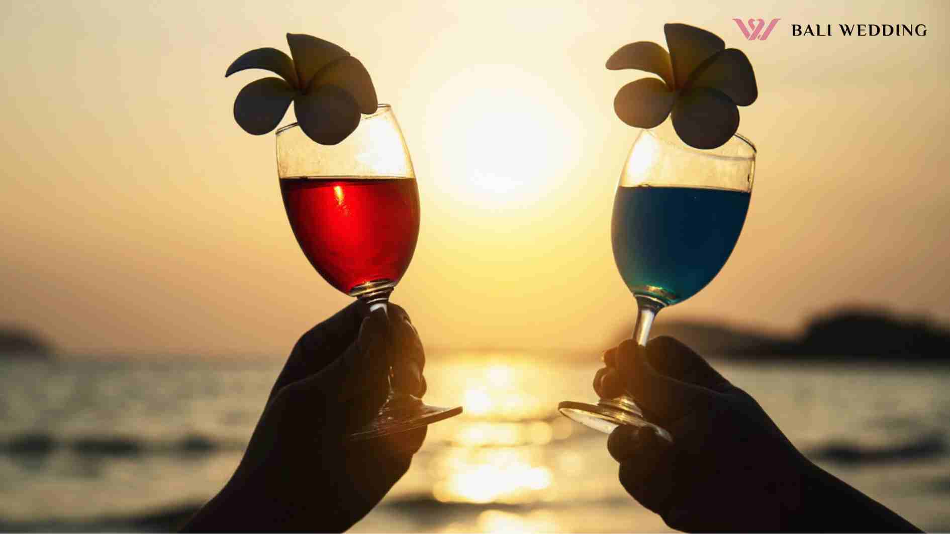 Silhouette couple hand holding cocktail glass decoration with plumeria flower with beach