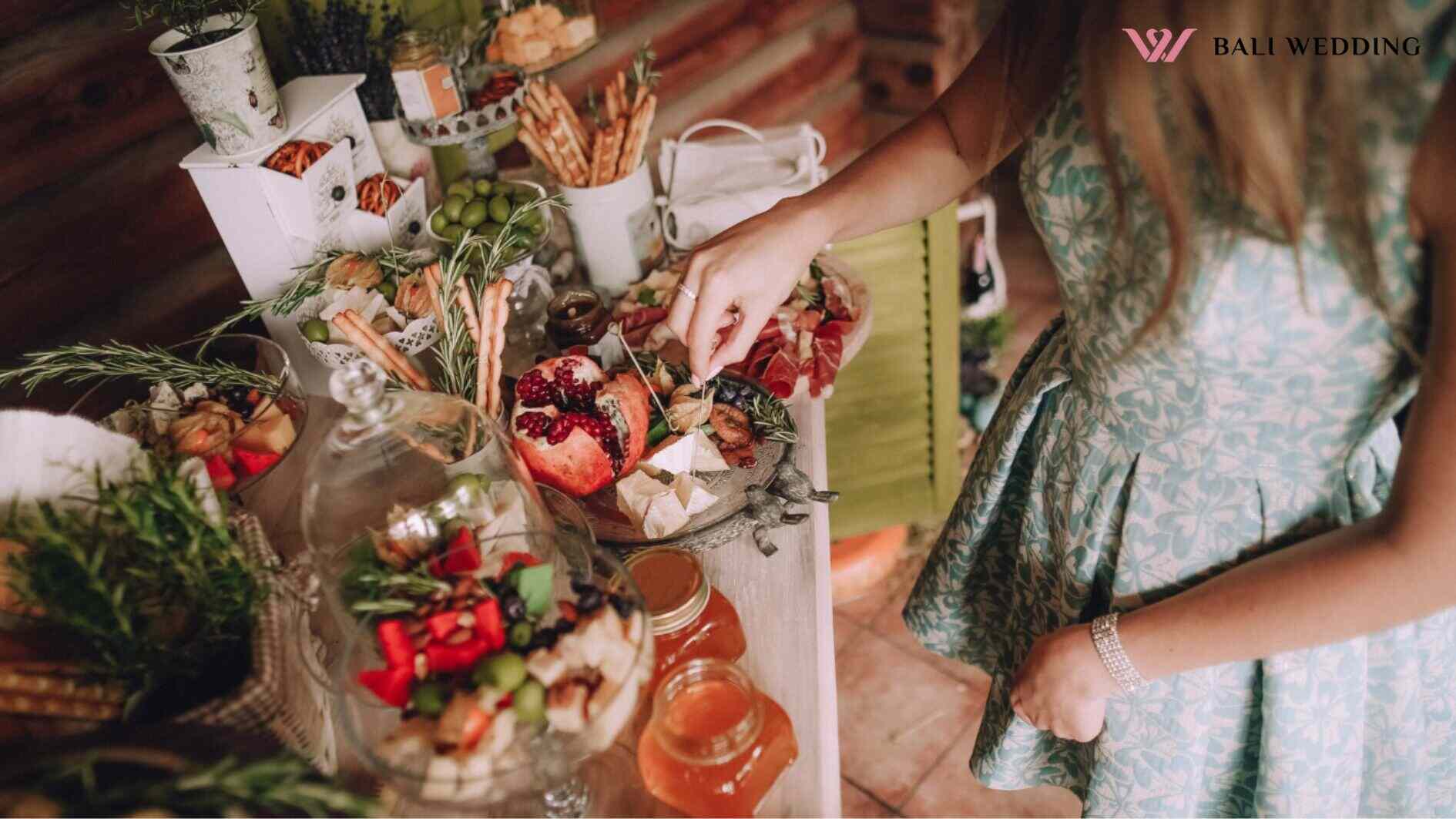 bridal shower, Girl takes a slice of cheese on a decorated table with cakes