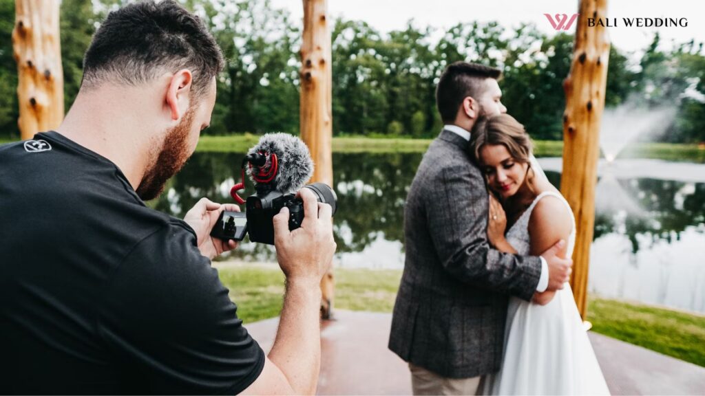 man in black t-shirt holding black dslr camera
