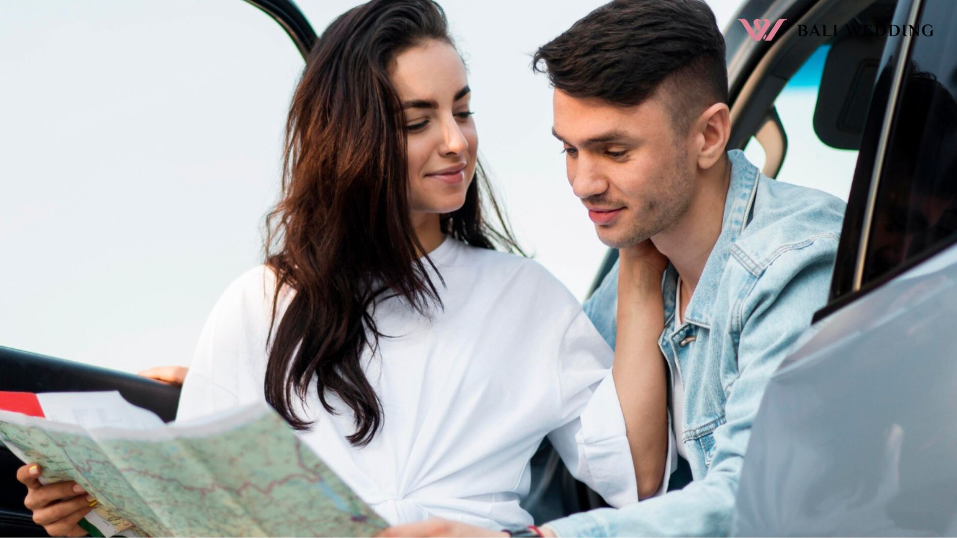 Couple looking on a map together medium shot